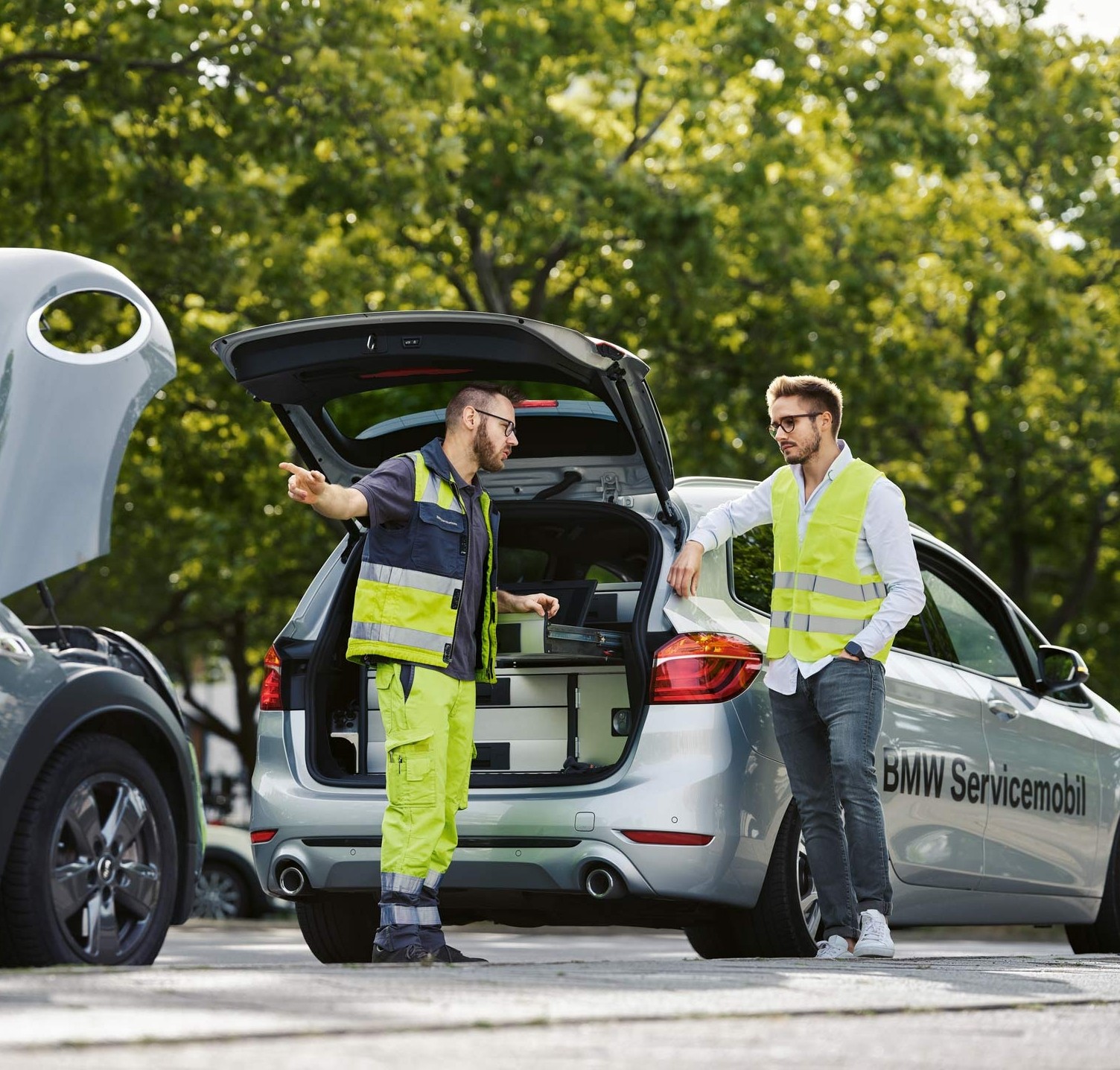 Roadside assistance team working from an open service vehicle on a city street